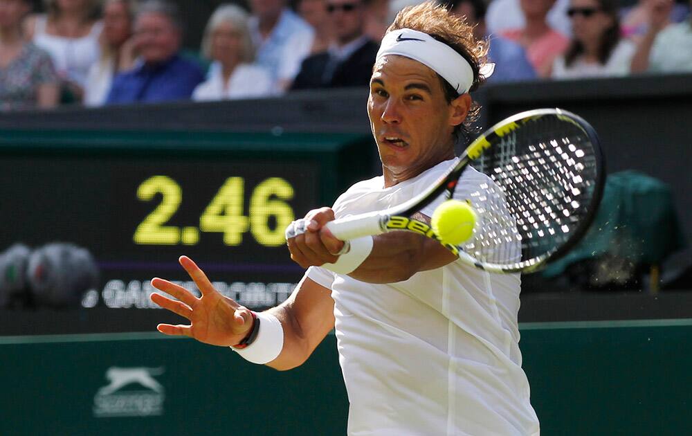 Rafael Nadal of Spain plays a return to Martin Klizan of Slovakia during their match at the All England Lawn Tennis Championships in Wimbledon.