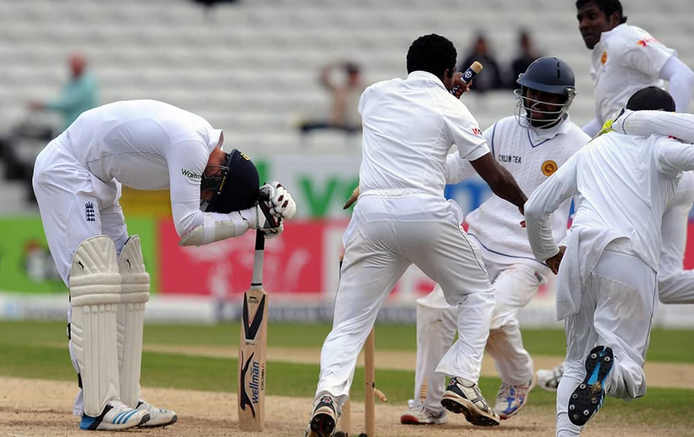 Sri Lanka's players celebrate after beating England by 100 runs as England's James Anderson reacts after being bowled by Sri Lanka's Shaminda Eranga, caught by Rangana Herath with the penultimate ball, during day five of the Second Test Match between England and Sri Lanka.