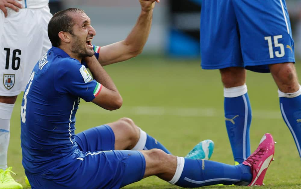 Italy's Giorgio Chiellini complains after Uruguay's Luis Suarez ran into Chiellini's shoulder during the group D World Cup soccer match between Italy and Uruguay at the Arena das Dunas in Natal, Brazil.