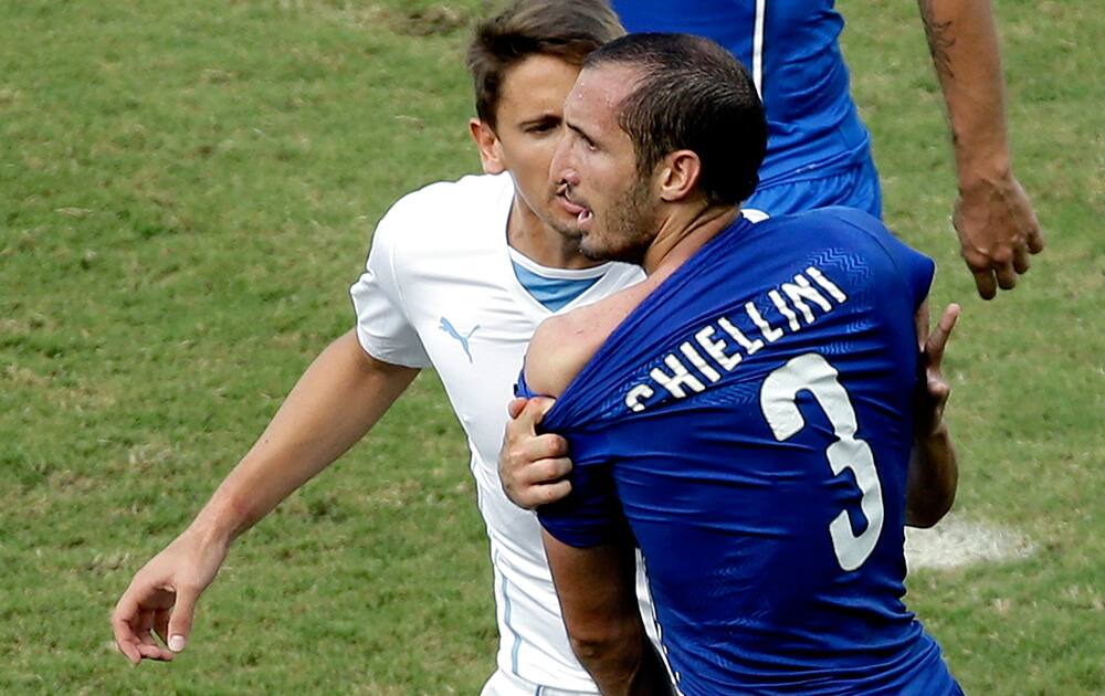 Italy's Giorgio Chiellini complains after Uruguay's Luis Suarez ran into his shoulder with his teeth during the group D World Cup soccer match between Italy and Uruguay at the Arena das Dunas in Natal, Brazil.