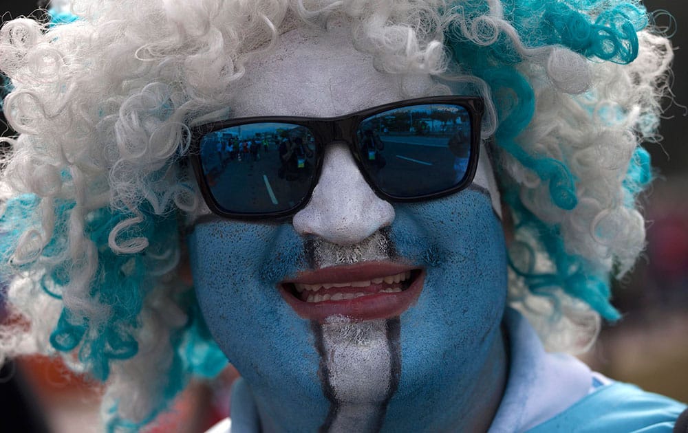 An Argentine soccer fan smiles as he heads to the stadium to watch the World Cup group F match between Argentina and Nigeria, in Porto Alegre, Brazil.