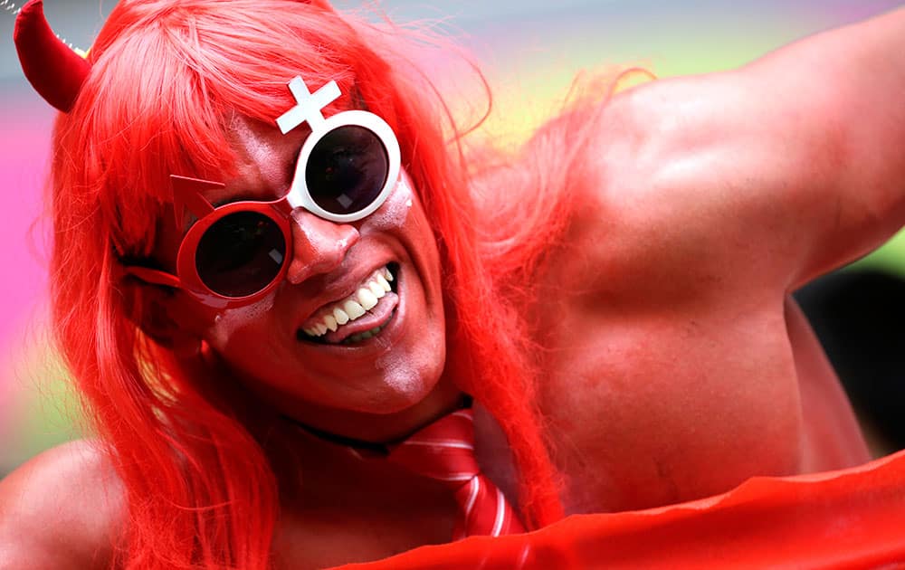 A fan of Switzerland cheers before the group E World Cup soccer match between Honduras and Switzerland at the Arena da Amazonia in Manaus, Brazil.