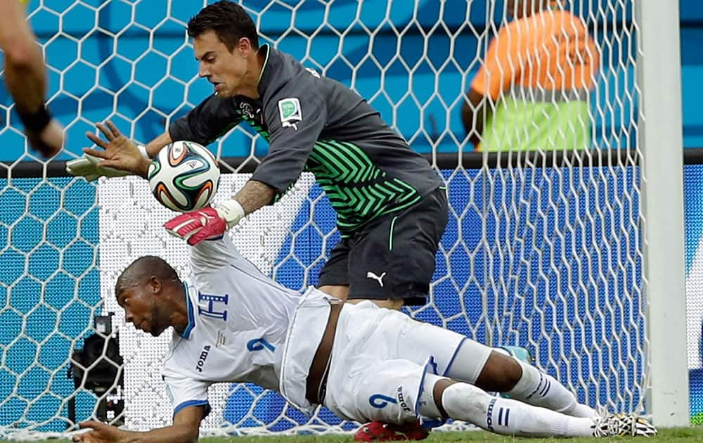 Switzerland's goalkeeper Diego Benaglio makes a save from Honduras' Jerry Palacios during the group E World Cup soccer match between Honduras and Switzerland at the Arena da Amazonia in Manaus, Brazil.