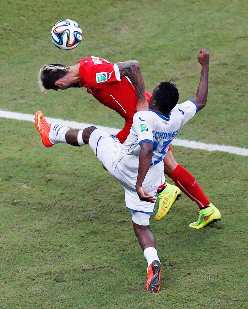 Honduras' Marvin Chavez battles Switzerland's Mario Gavranovic during the group E World Cup soccer match between Honduras and Switzerland at the Arena da Amazonia in Manaus, Brazil.