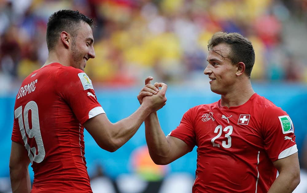 Switzerland's Xherdan Shaqiri, right, celebrates with Switzerland's Josip Drmic after scoring his side's second goal during the group E World Cup soccer match between Honduras and Switzerland at the Arena da Amazonia in Manaus, Brazil.