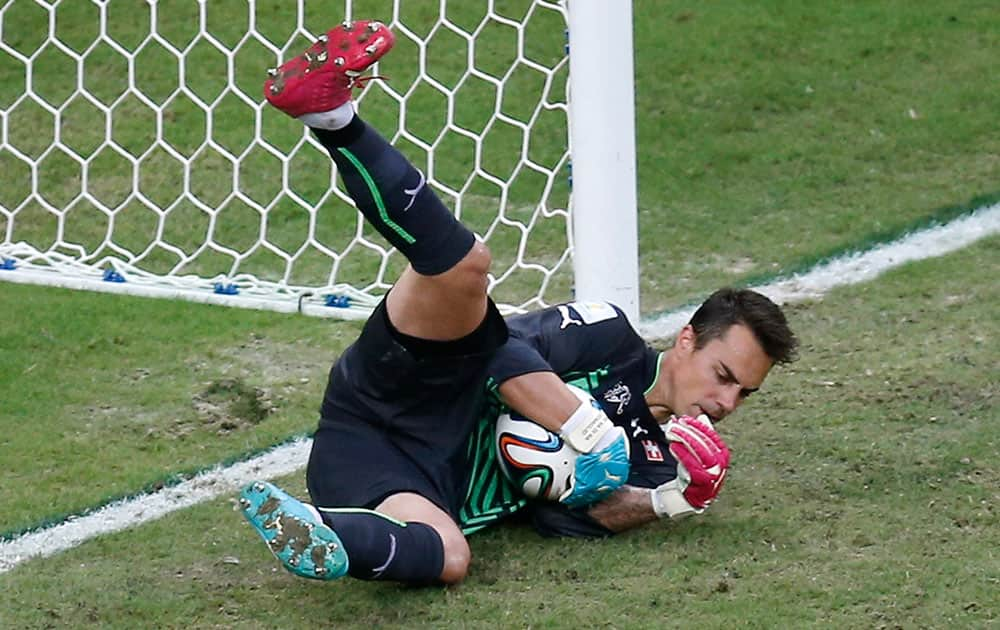 Switzerland's goalkeeper Diego Benaglio makes a save during the group E World Cup soccer match between Honduras and Switzerland at the Arena da Amazonia in Manaus, Brazil.