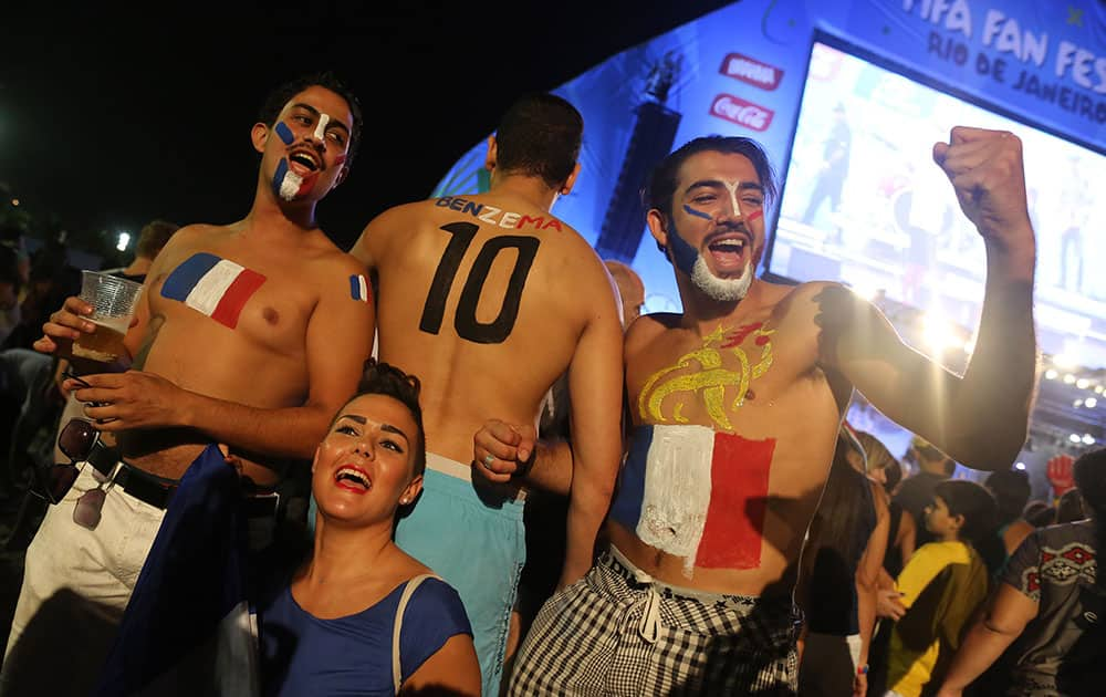 French soccer fans pose for photos after watching a live telecast of the World Cup group E match between France and Ecuador inside the FIFA Fan Fest area on Copacabana beach, in Rio de Janeiro, Brazil.