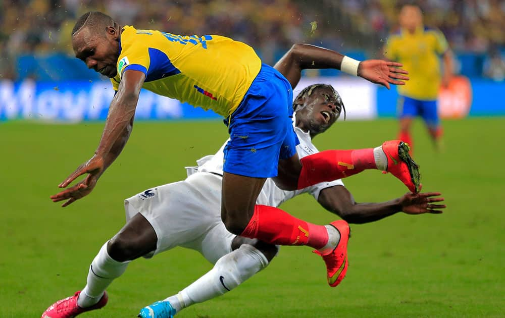 Ecuador's Walter Ayovi collides with France's Bacary Sagna during the group E World Cup soccer match between Ecuador and France at the Maracana Stadium in Rio de Janeiro, Brazil.