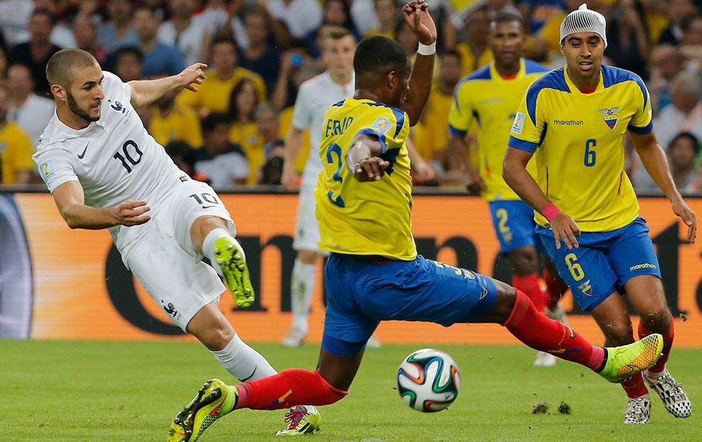 Ecuador's Frickson Erazo, front, blocks a shot by France's Karim Benzema, left, during the group E World Cup soccer match between Ecuador and France at the Maracana stadium in Rio de Janeiro, Brazil.