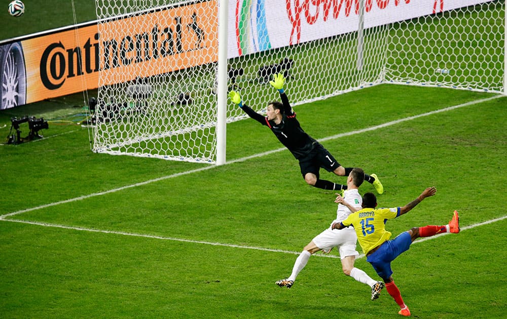 Ecuador's Michael Arroyo (15) takes a shot which goes wide past France's goalkeeper Hugo Lloris as France's Laurent Koscielny defends during the group E World Cup soccer match between Ecuador and France at the Maracana Stadium in Rio de Janeiro, Brazil.