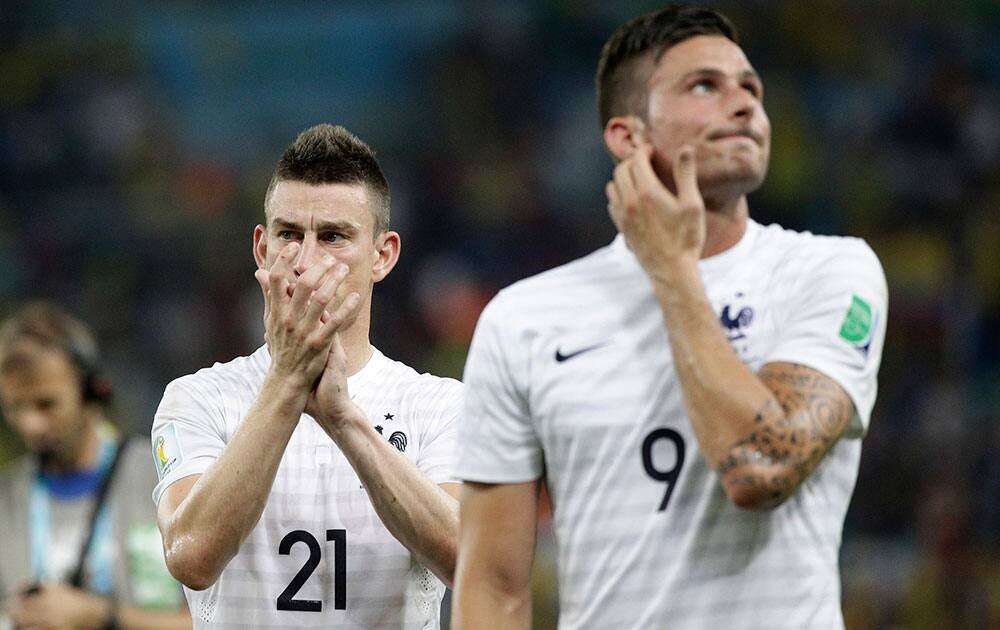 France's Laurent Koscielny, left, and Olivier Giroud leave the pitch after the group E World Cup soccer match between Ecuador and France at the Maracana Stadium in Rio de Janeiro, Brazil.