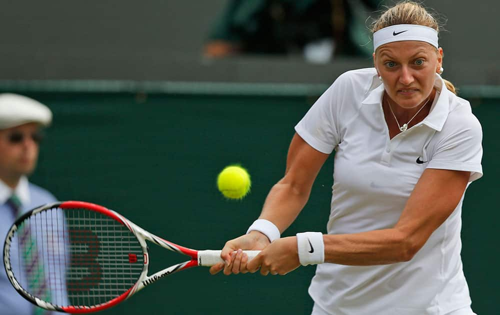 Petra Kvitova of the Czech Republic returns to Mona Barthel of Germany during their women's singles match at the All England Lawn Tennis Championships in Wimbledon.