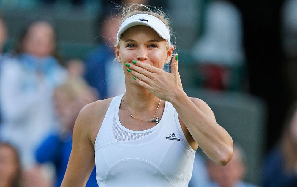 Caroline Wozniacki of Denmark sends a kiss to the crowd after defeating Naomi Broady of Britain in their women's singles match at the All England Lawn Tennis Championships in Wimbledon.