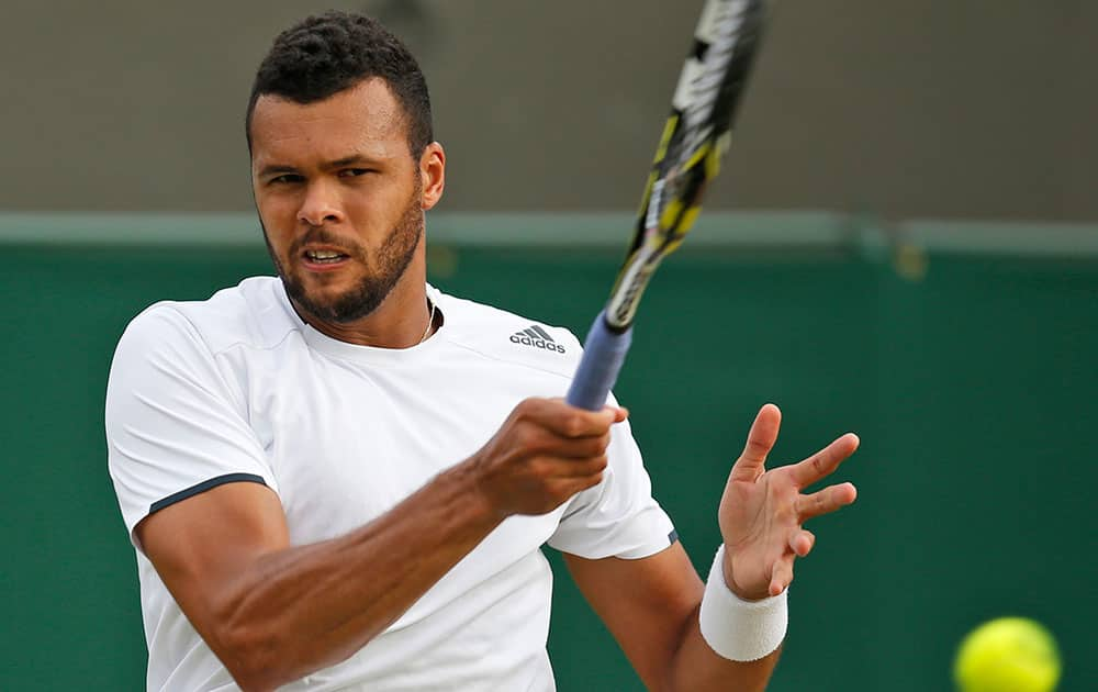 Jo-Wilfried Tsonga of France watches a return to Sam Querrey of US during their men's singles match at the All England Lawn Tennis Championships in Wimbledon.