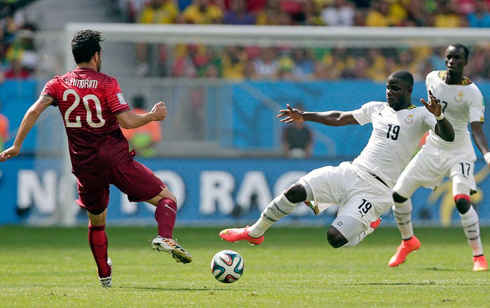 Ghana's Jonathan Mensah and Portugal's Ruben Amorim, left, go for the ball during the group G World Cup soccer match between Portugal and Ghana at the Estadio Nacional in Brasilia, Brazil.