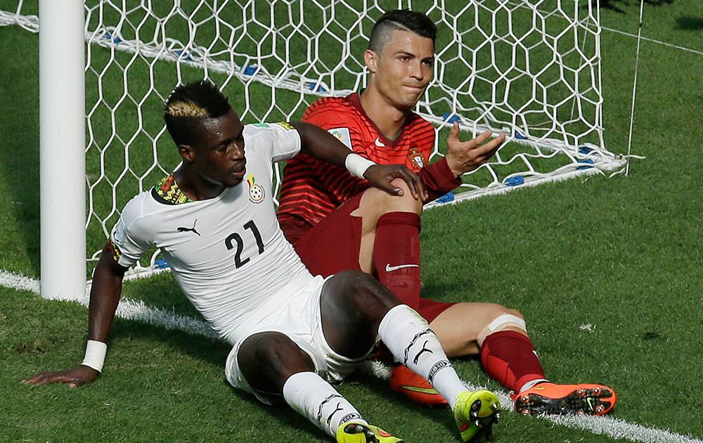 Portugal's Cristiano Ronaldo, right, reacts after tangling with Ghana's John Boye, left, during the group G World Cup soccer match between Portugal and Ghana at the Estadio Nacional in Brasilia, Brazil.