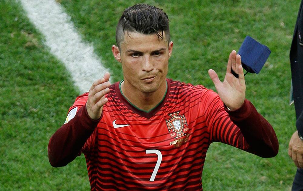 Portugal's Cristiano Ronaldo waves as he leaves the pitch following the group G World Cup soccer match between Portugal and Ghana at the Estadio Nacional in Brasilia, Brazil.