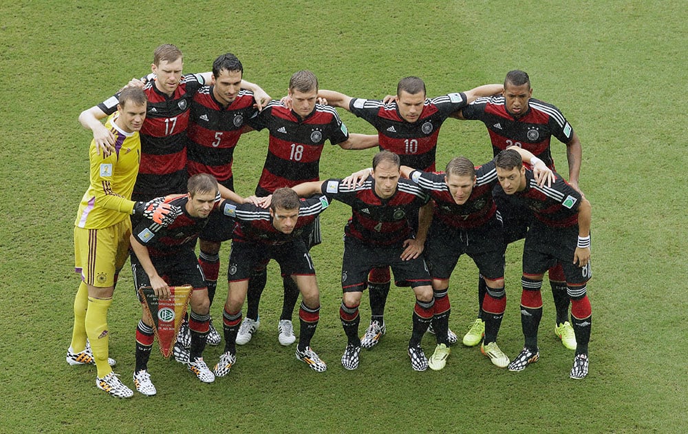 The team from Germany pose for their team photo before the group G World Cup soccer match between the USA and Germany at the Arena Pernambuco in Recife, Brazil