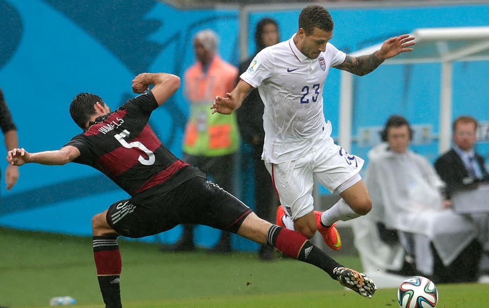 Germany's Mats Hummels, left, and United States' Fabian Johnson challenge for the ball during the group G World Cup soccer match between the USA and Germany at the Arena Pernambuco in Recife, Brazil.