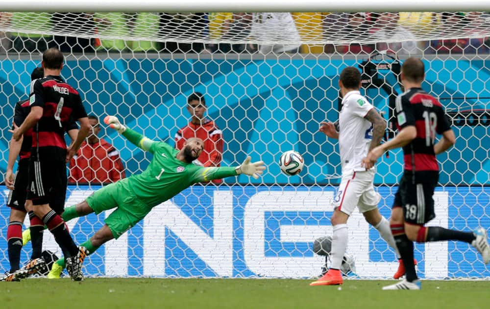 United States' goalkeeper Tim Howard can not stop a shot by Germany's Thomas Mueller to score his side's first goal during the group G World Cup soccer match between the United States and Germany at the Arena Pernambuco in Recife, Brazil.