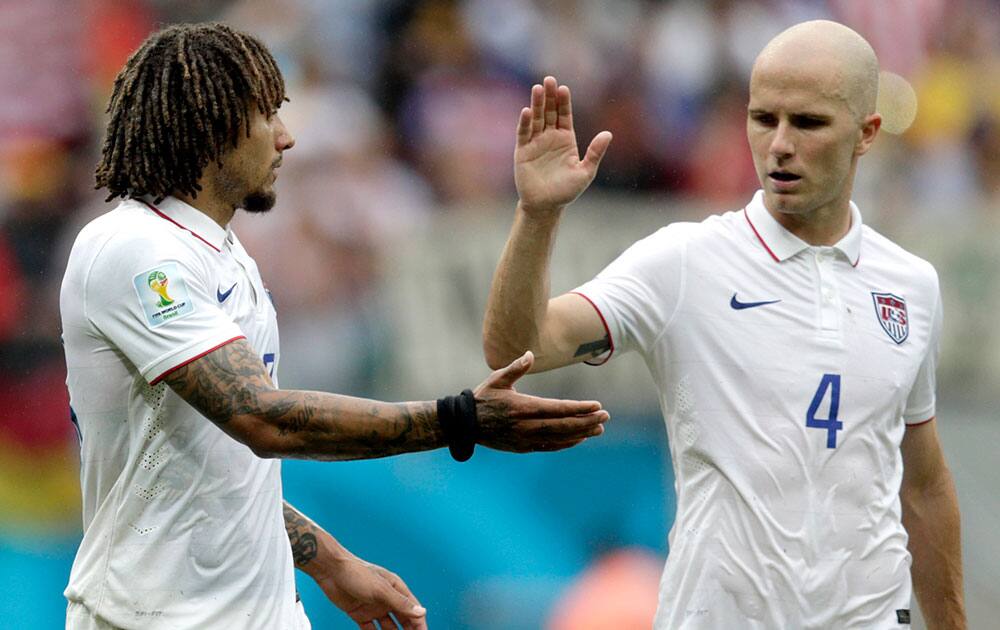 United States' Michael Bradley, right, congratulates his teammate Jermaine Jones after qualifying for the next World Cup round following their 1-0 loss to Germany during the group G World Cup soccer match between the USA and Germany at the Arena Pernambuco in Recife, Brazil.