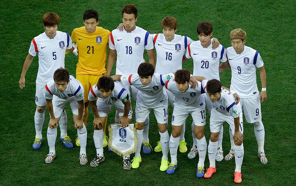 The team from South Korea pose for a team photo before the group H World Cup soccer match between South Korea and Belgium at the Itaquerao Stadium in Sao Paulo, Brazil