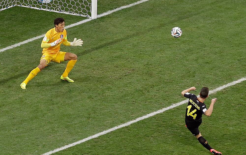 Belgium's Dries Mertens (14) takes a shot towards the South Korea's goalkeeper Kim Seung-gyu which goes high during the group H World Cup soccer match between South Korea and Belgium at the Itaquerao Stadium in Sao Paulo, Brazil.