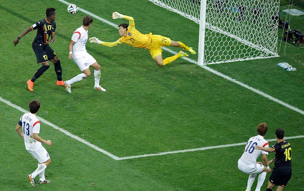 South Korea's goalkeeper Kim Seung-gyu, center top, makes a save on a shot by Belgium's Eden Hazard (10) during the group H World Cup soccer match between South Korea and Belgium at the Itaquerao Stadium in Sao Paulo, Brazil.