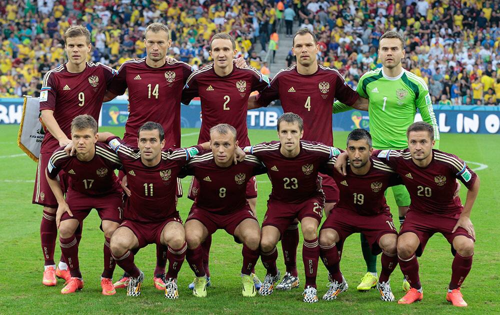 The Russian team pose for a group photo before the group H World Cup soccer match between Algeria and Russia at the Arena da Baixada in Curitiba, Brazil.