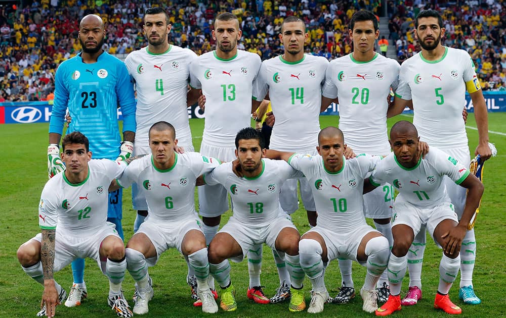 Algeria's team pose for pictures during the group H World Cup soccer match between Algeria and Russia at the Arena da Baixada in Curitiba, Brazil.