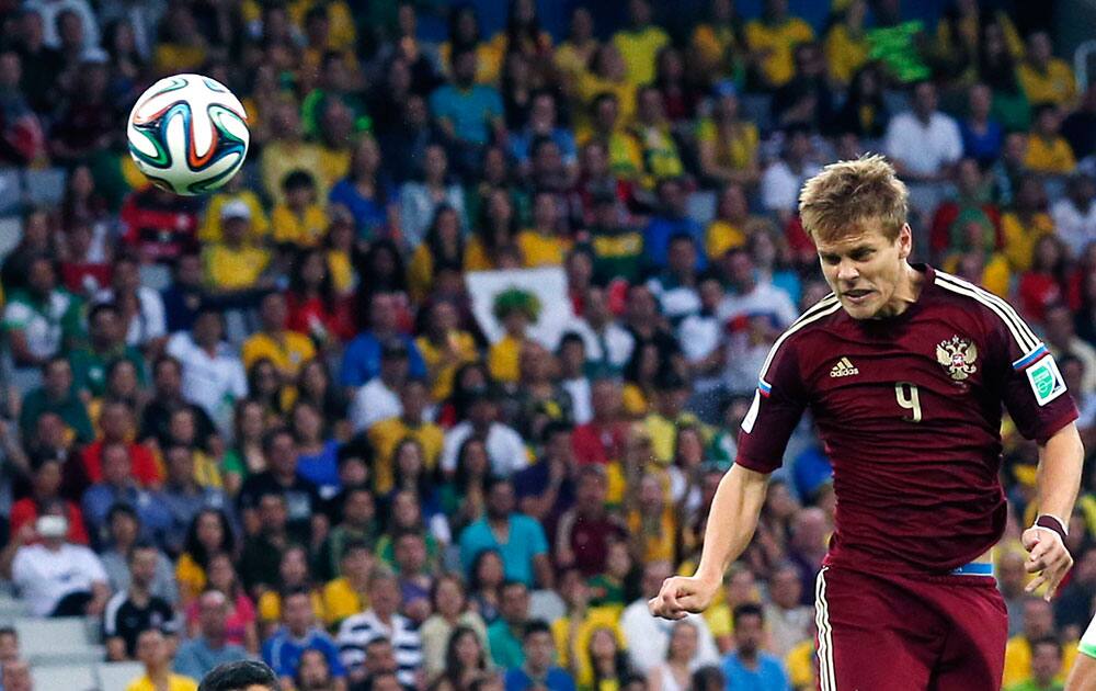 Russia's Alexander Kokorin scores a header during the group H World Cup soccer match between Algeria and Russia at the Arena da Baixada in Curitiba, Brazil.