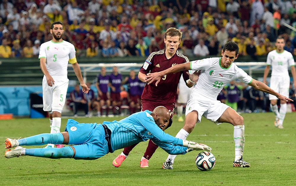 Algeria's goalkeeper Rais M’Bolhi makes a save during the group H World Cup soccer match between Algeria and Russia at the Arena da Baixada in Curitiba, Brazil.