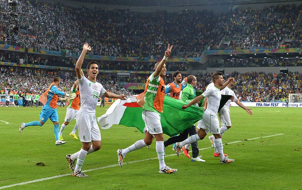 Algerian players celebrate after the group H World Cup soccer match between Algeria and Russia at the Arena da Baixada in Curitiba, Brazil.