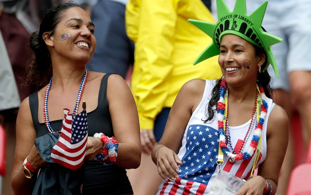 USA supporters celebrate after the national team qualified for the next World Cup round following their 1-0 loss to Germany during the group G World Cup soccer match between the USA and Germany at the Arena Pernambuco in Recife, Brazil.