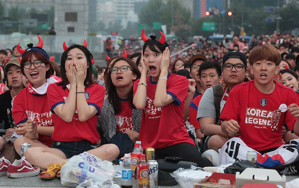 South Korean soccer fans watch a live broadcast of the Group H World Cup soccer match between South Korea and Belgium at a public viewing venue in Seoul, South Korea