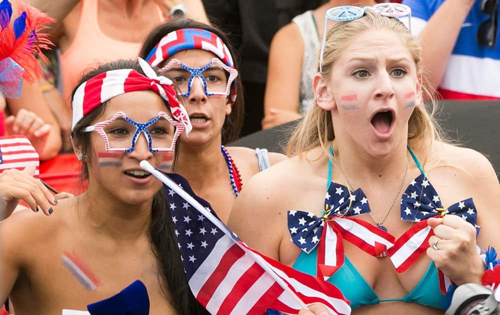 US soccer fans from left, Lauryn De la Torre, 19, Shayda Ansari, 21, and Lindsay Beeder, 19, watch the telecast of the 2014 World Cup Brazil between US and Germany in Hermosa Beach, Calif.