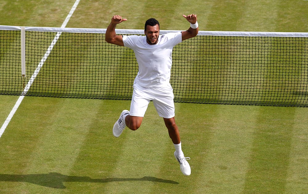 Jo-Wilfried Tsonga of France celebrates winning the men's singles match against Sam Querrey of the U.S. at the All England Lawn Tennis Championships in Wimbledon, London.