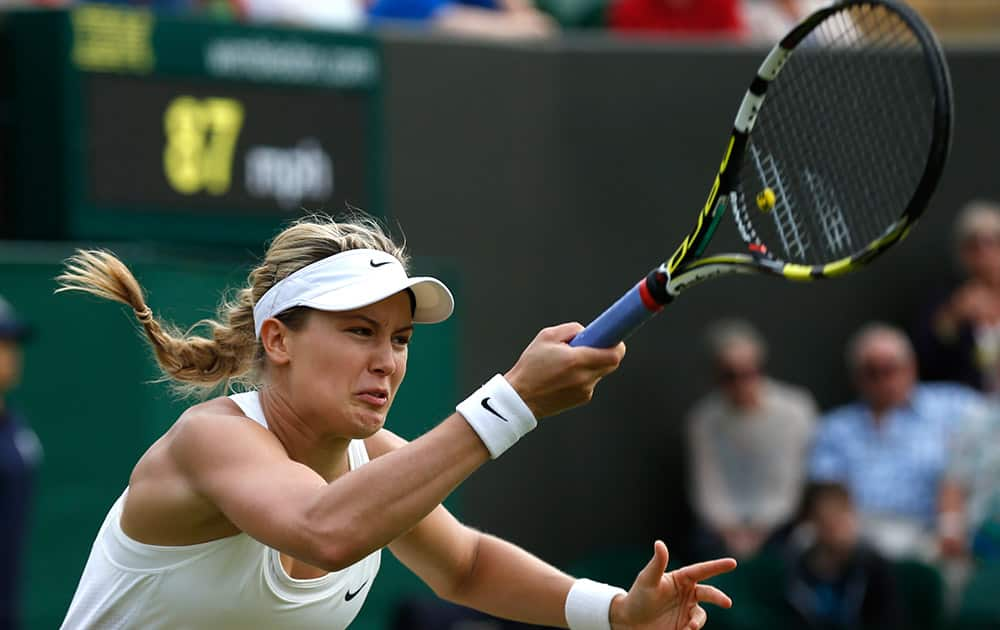 Eugenie Bouchard of Canada plays a return to Silvia Soler-Espinosa of Spain during their women's singles match at the All England Lawn Tennis Championships in Wimbledon, London.