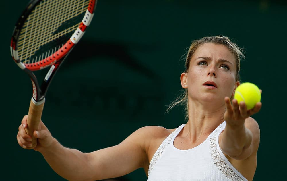 Camila Giorgi of Italy prepares to serve to Alison Riske of U.S. during their women's singles match at the All England Lawn Tennis Championships in Wimbledon, London.