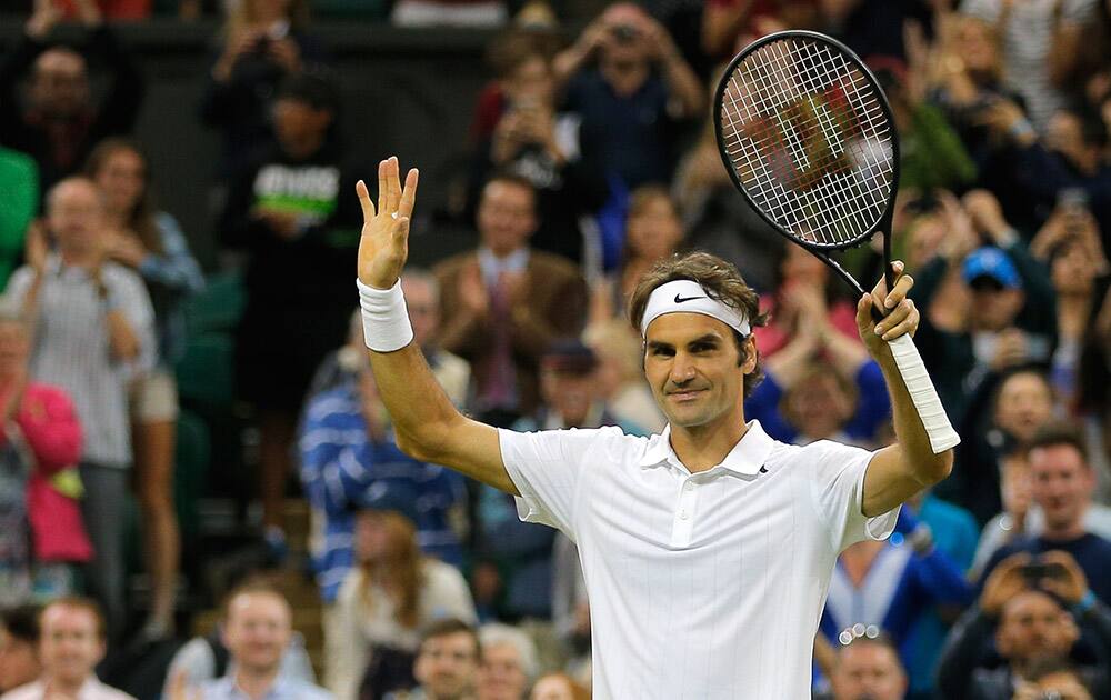 Roger Federer of Switzerland celebrates after defeating Gilles Muller of Luxembourg in their men's singles match at the All England Lawn Tennis Championships in Wimbledon, London.