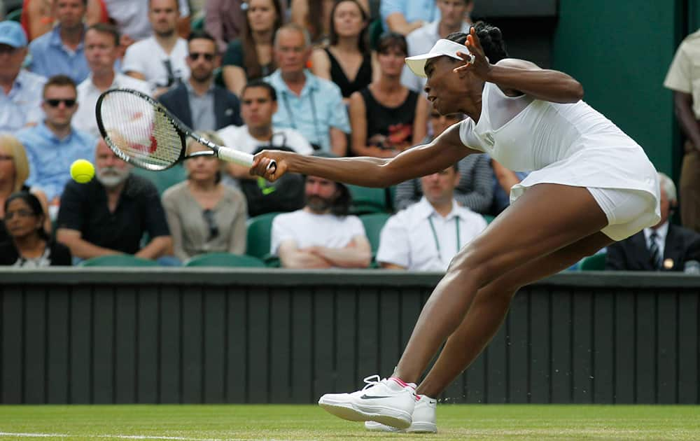 Venus Williams of U.S. returns to Petra Kvitova of the Czech Republic during their women's singles match at the All England Lawn Tennis Championships in Wimbledon, London.