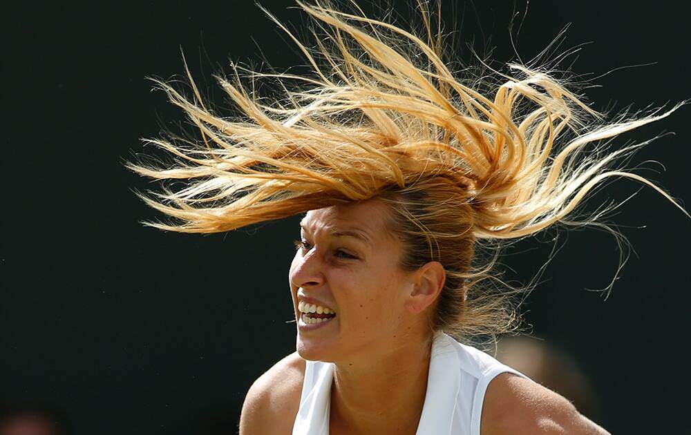 Domimika Cibulkova of Slovakia serves to Lucie Safarova of Czech Republic during their women's singles match at the All England Lawn Tennis Championships in Wimbledon, London.