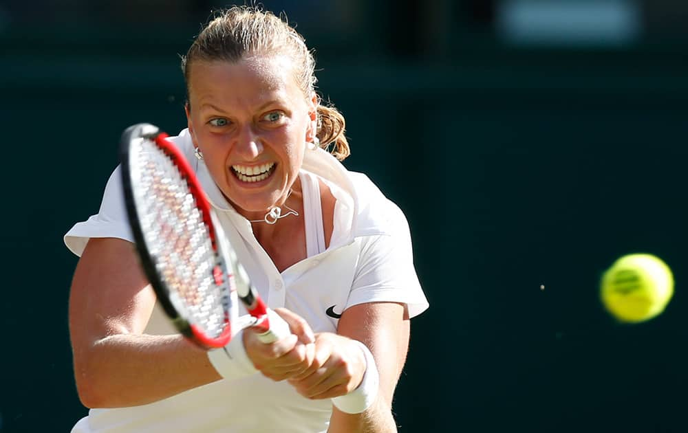 Petra Kvitova of the Czech Republic returns to Venus Williams of U.S. during their women's singles match at the All England Lawn Tennis Championships in Wimbledon, London.