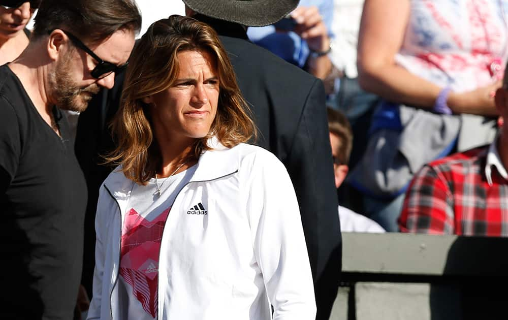 British comic actor Ricky Gervais and Amelie Mauresmo, coach of Britain's Andy Murray, stand in the players box ahead of the men's singles match between Andy Murray and Roberto Bautista Agut of Spain at the All England Lawn Tennis Championships in Wimbledon, London.