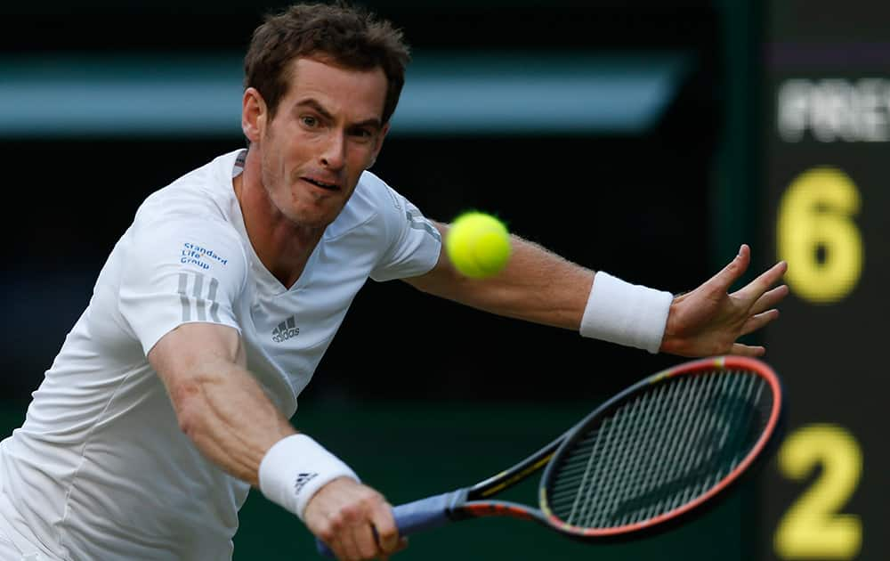 Andy Murray of Britain plays a return to Roberto Bautista Agut of Spain during their men's singles match at the All England Lawn Tennis Championships in Wimbledon, London.