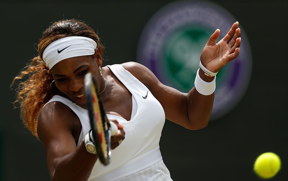 Serena Williams of U.S. plays a return to Alize Cornet of France during their women's singles match at the All England Lawn Tennis Championships in Wimbledon, London.