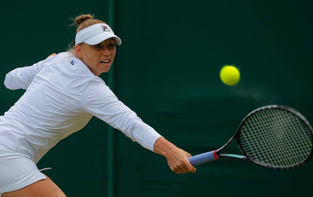 Vera Zvonareva of Russia plays a return to Zarina Diyas of Kazakhstan during their women's singles match at the All England Lawn Tennis Championships in Wimbledon, London.