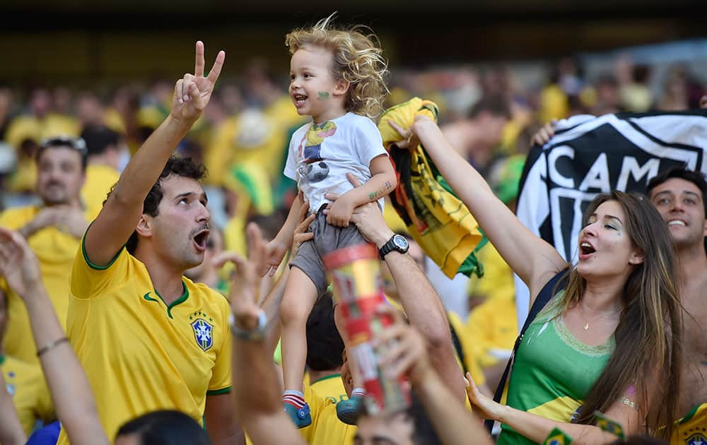 Brazilian supporters celebrate after a penalty shoot out at the end of the World Cup round of 16 soccer match between Brazil and Chile at the Mineirao Stadium in Belo Horizonte, Brazil.