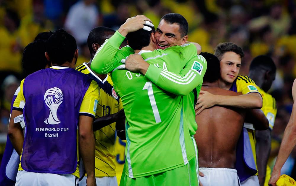 Colombia's goalkeeper Faryd Mondragon embraces goalkeeper David Ospina after the World Cup round of 16 soccer match between Colombia and Uruguay at the Maracana Stadium in Rio de Janeiro, Brazil.