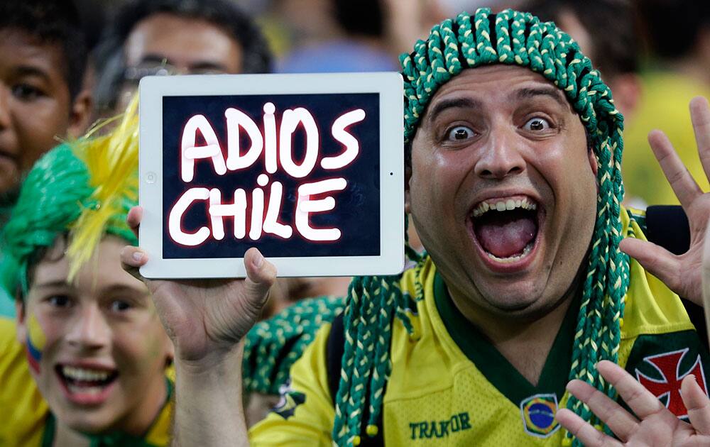 A Brazilian supporter holds up a message for their beaten opponents after the World Cup round of 16 soccer match between Colombia and Uruguay at the Maracana Stadium in Rio de Janeiro, Brazil.